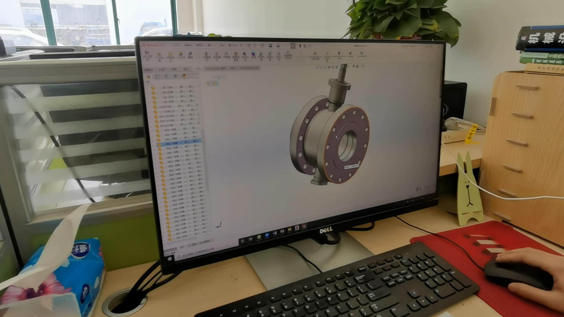 A technician uses SolidWorks to develop a 3D model of a high-temperature industrial damper.