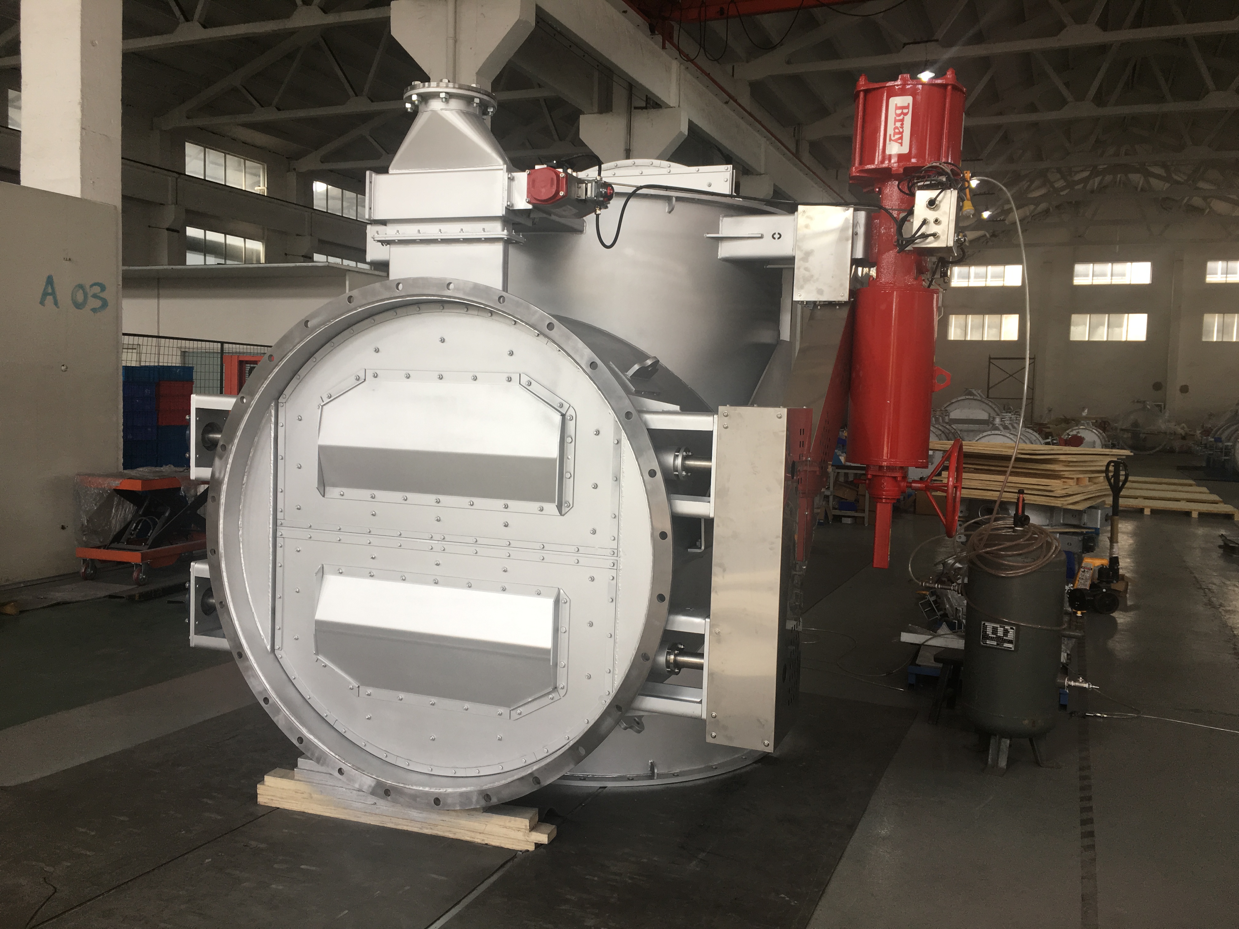 Front photo of a large three way flue multi shaft gas sealing diverter damper equipped with a fork type pneumatic actuator and a position sensor used for flue gas bypass switching in a power plants desulfurization system