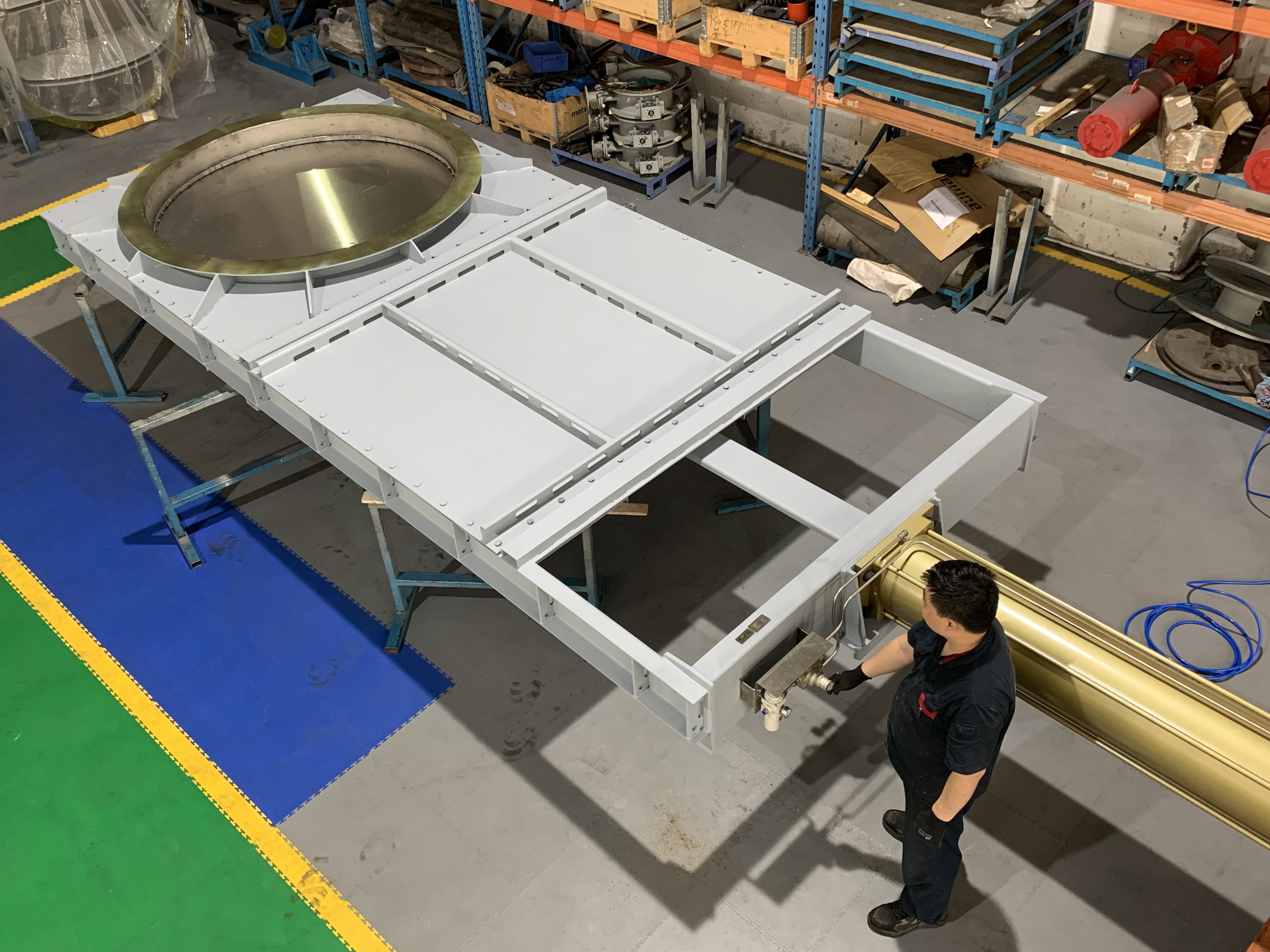 Custom large pneumatic guillotine isolation damper being tested in the workshop equipped with a pneumatic actuator reinforced welded valve body used for high temperature flue gas isolation in the petroleum heater