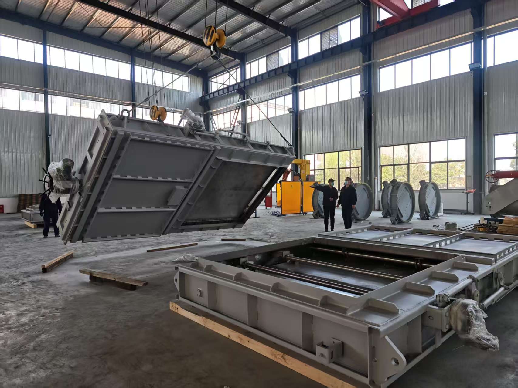 Large electric guillotine isolation damper being moved around the workshop with an electric actuator reinforced welded valve body used for flue gas isolation in a power plants desulfurization system