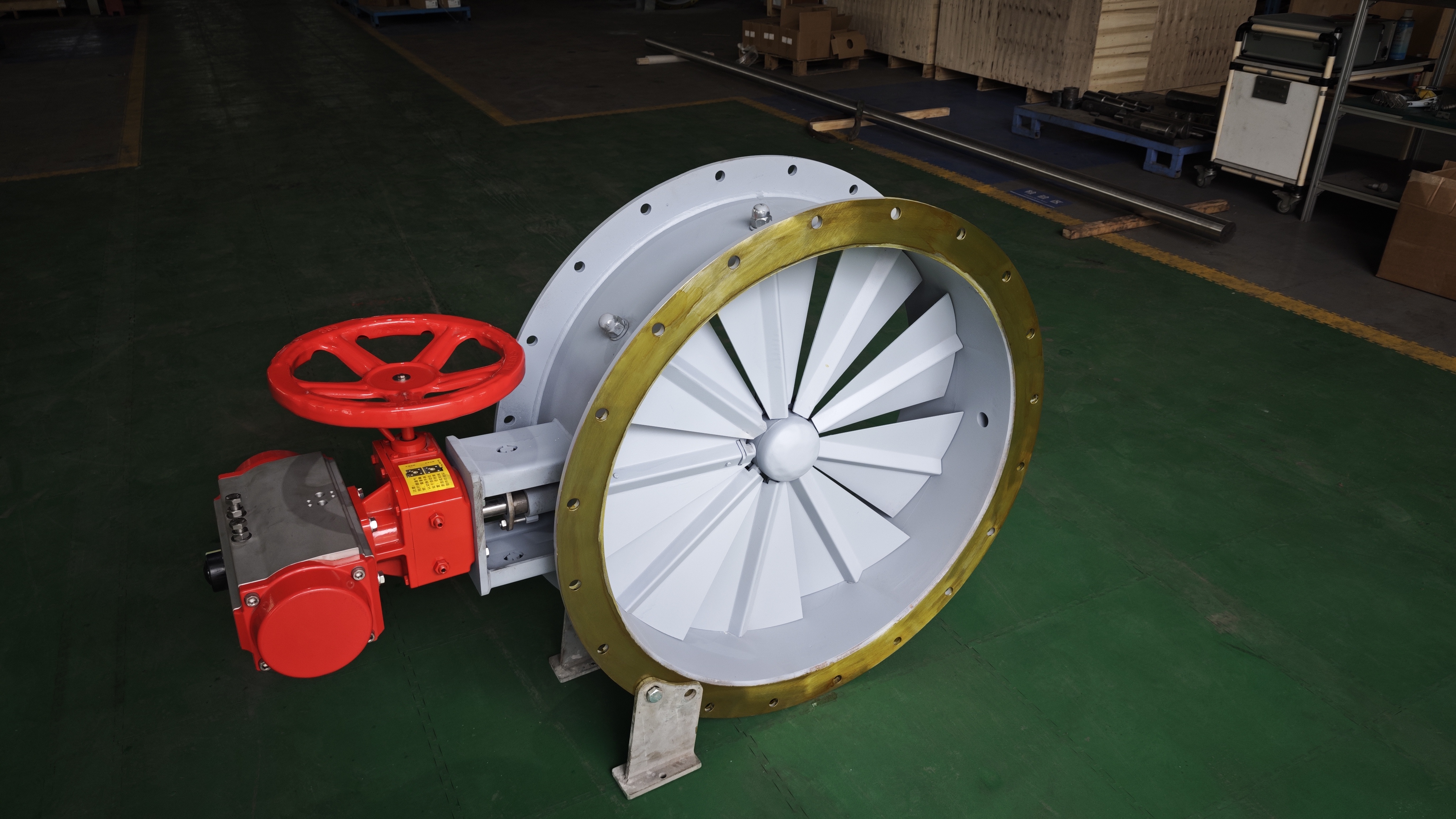 The workshop is showing the completed inlet vane control damper with a built in fork equipped with a pneumatic actuator and a manual handwheel used for precise flow regulation at the centrifugal fan inlet