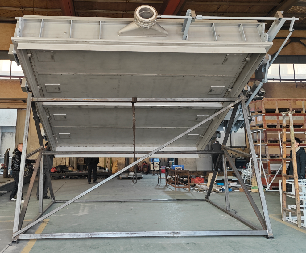 A large rectangular multi louver air sealing flue isolation damper supported in the workshop with an external linkage drive system used for flue gas isolation in power plant desulfurization systems