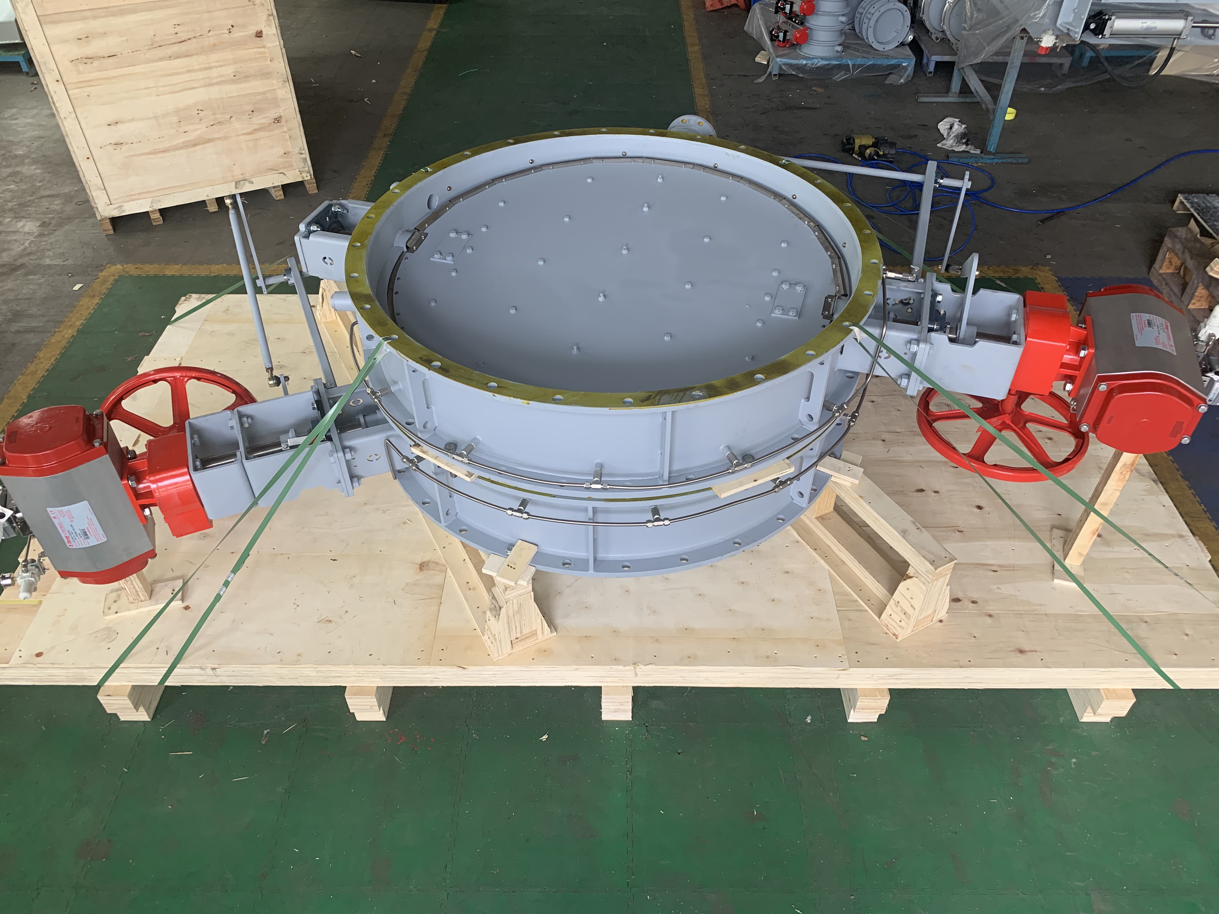 In the workshop theres a circular pneumatic air sealing isolation butterfly damper by a linkage equipped with a pneumatic actuator and a gas purging system zero leakage used for ship exhaust cleaning systems